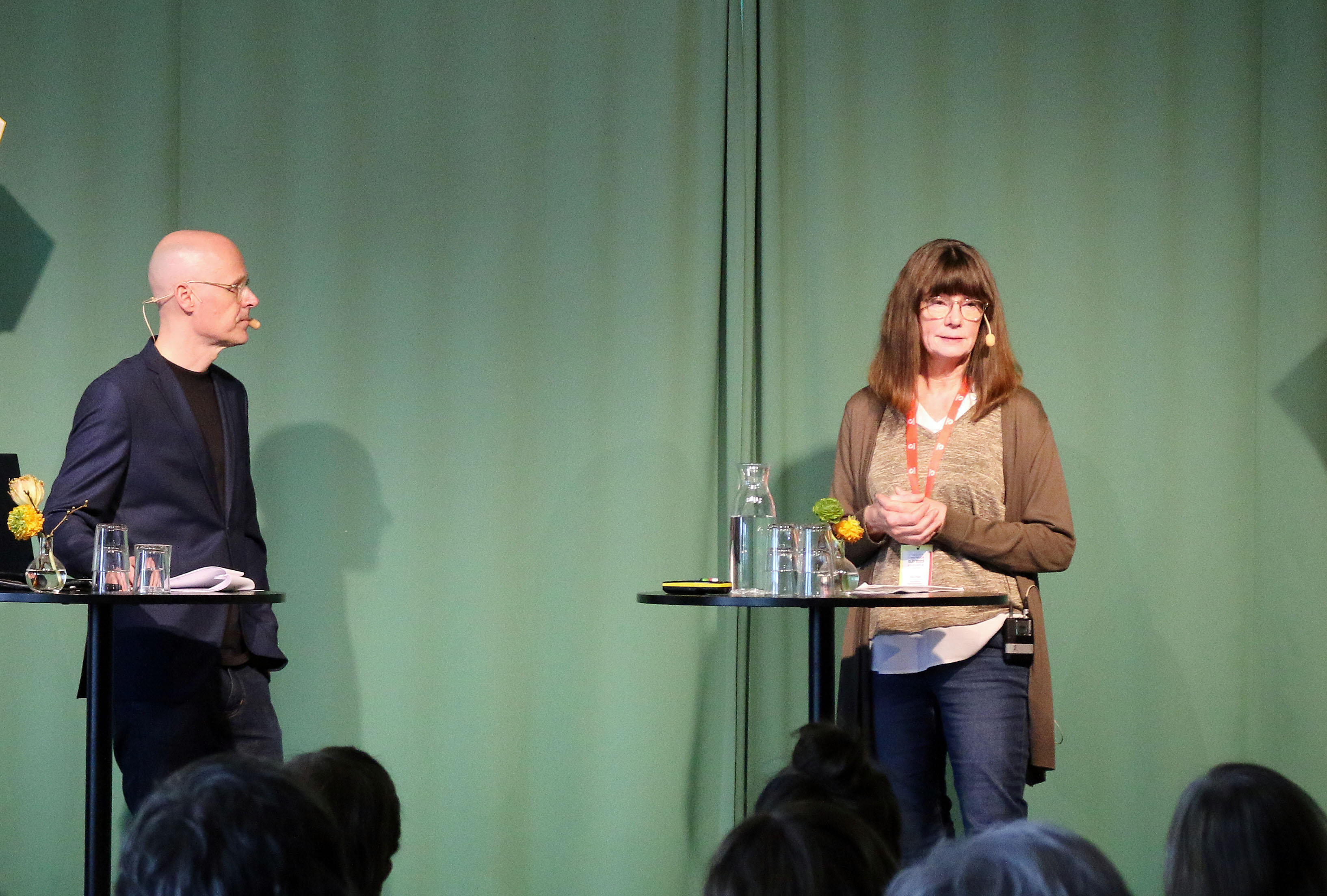Anders Mildner och Paula Trogen på en scen.